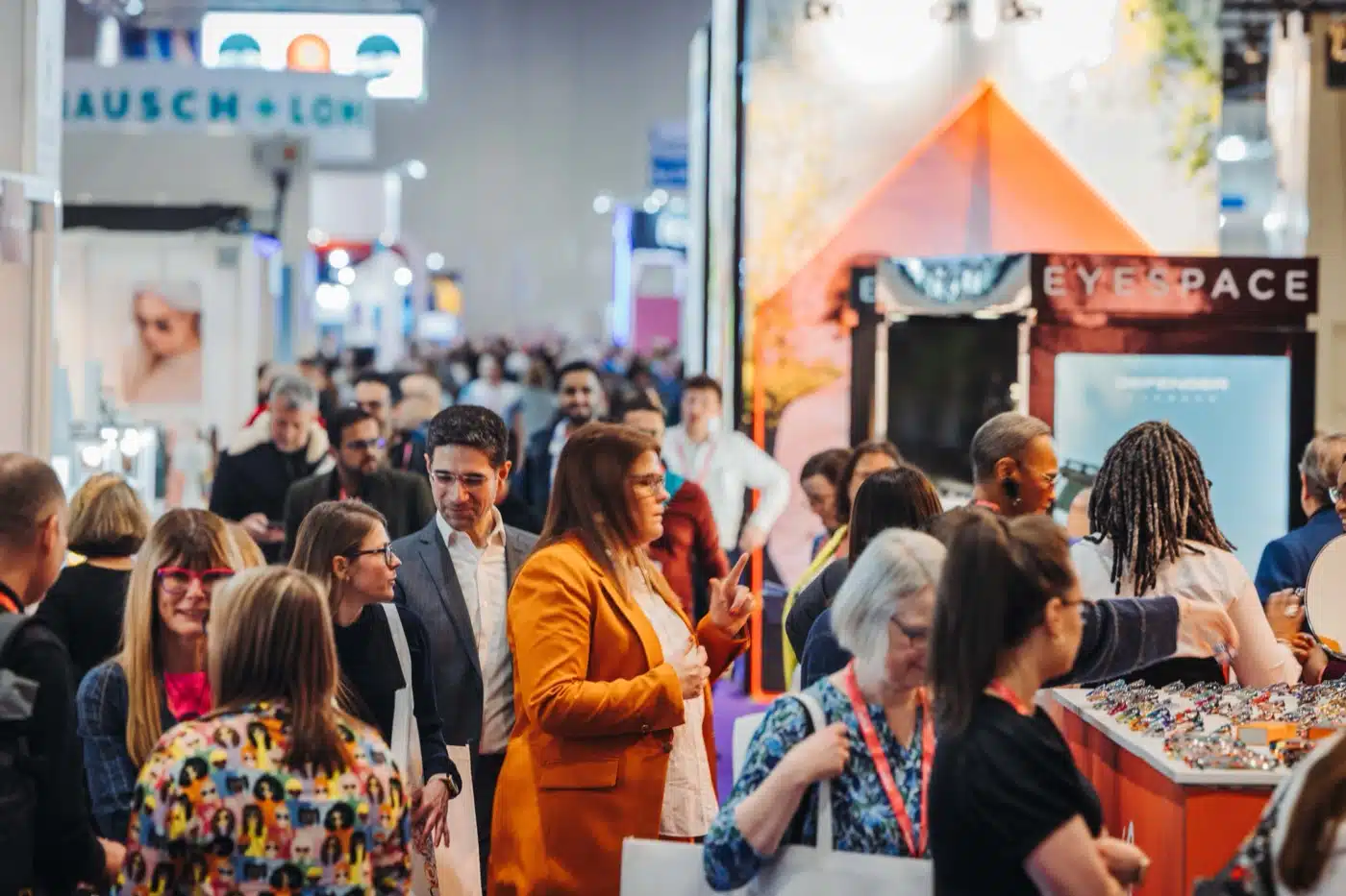 Crowds exploring innovative eyewear trends and networking at the 100% Optical show, a leading vision care event in London.