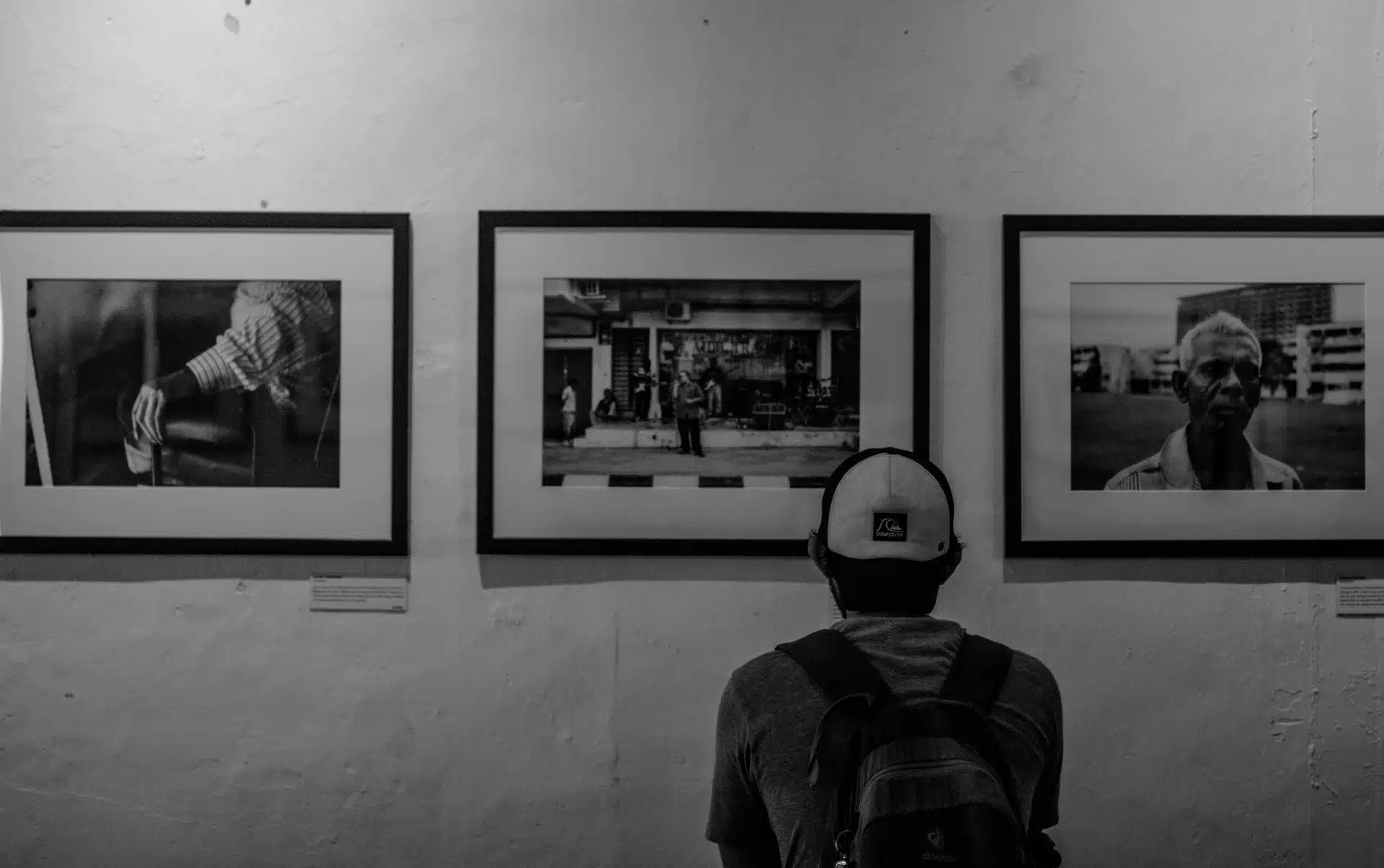 Visitor admiring black-and-white photography in a minimalist setting—exploring the Best Art Galleries in London experience.