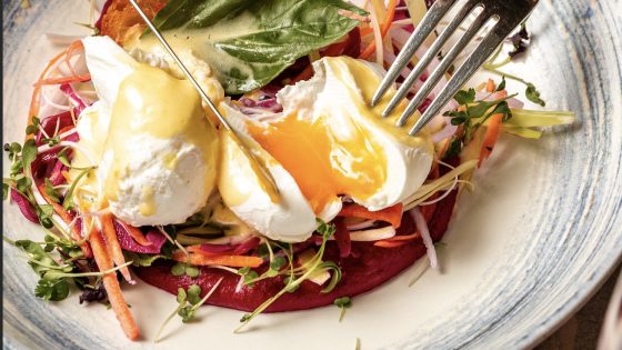 A vibrant dish with poached eggs, fresh veggies, and hollandaise sauce served at Fremantle Bar & Kitchen, perfect for brunch lovers.