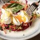 A vibrant dish with poached eggs, fresh veggies, and hollandaise sauce served at Fremantle Bar & Kitchen, perfect for brunch lovers.