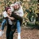 Couple enjoying a playful moment in a leafy park surrounded by autumn vibes, highlighting Romantic Things to Do in London for Free