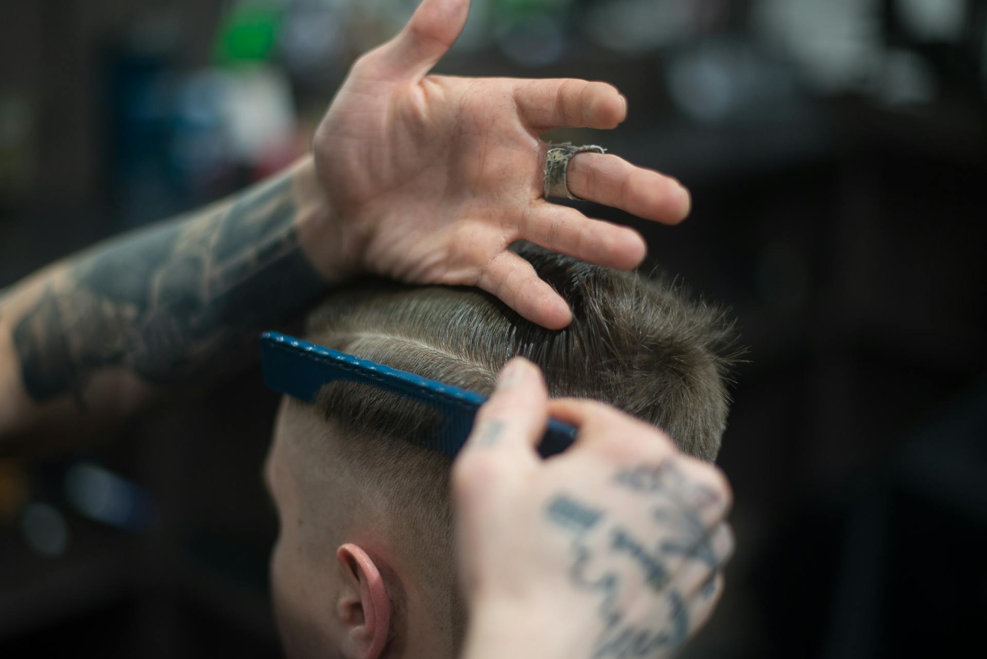 Close-up of a stylist’s hands perfecting The Dutch Braid haircut, showcasing precision and modern grooming techniques in London.