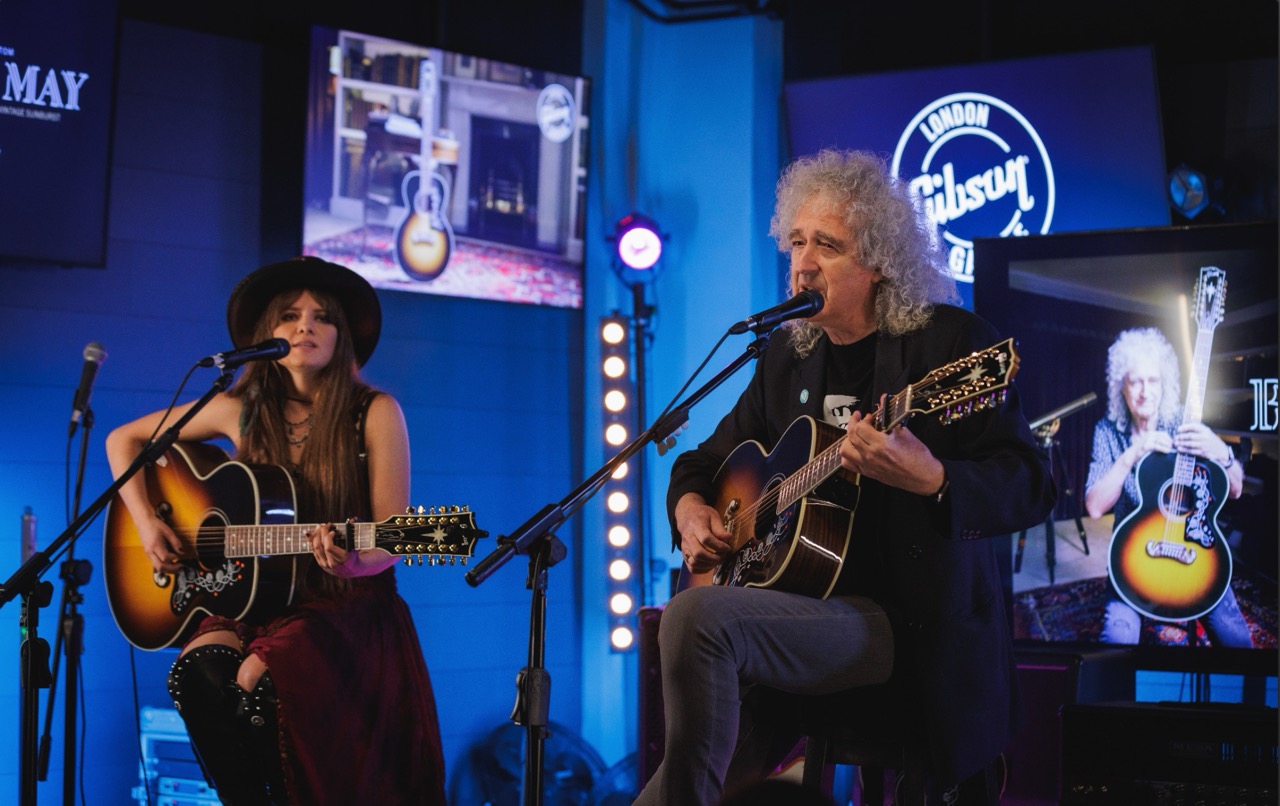 Sir Brian May at Gibson Garage London, performing live with acoustic guitar at an exclusive event.