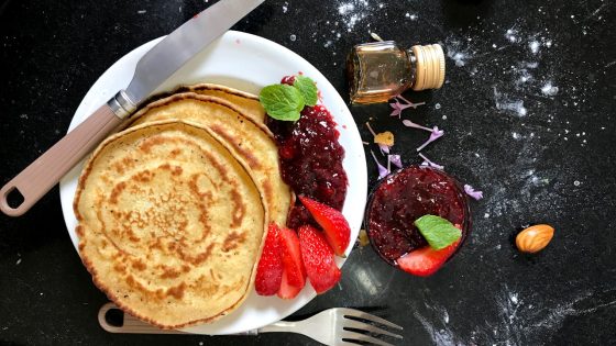 Fluffy pancakes with fresh strawberries and jam—discover Where to Eat Pancakes in London for the best brunch spots in the city.