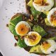 Avocado toast with eggs and pine nuts, a budget-friendly meal option featured in our cheap eats in London guide.