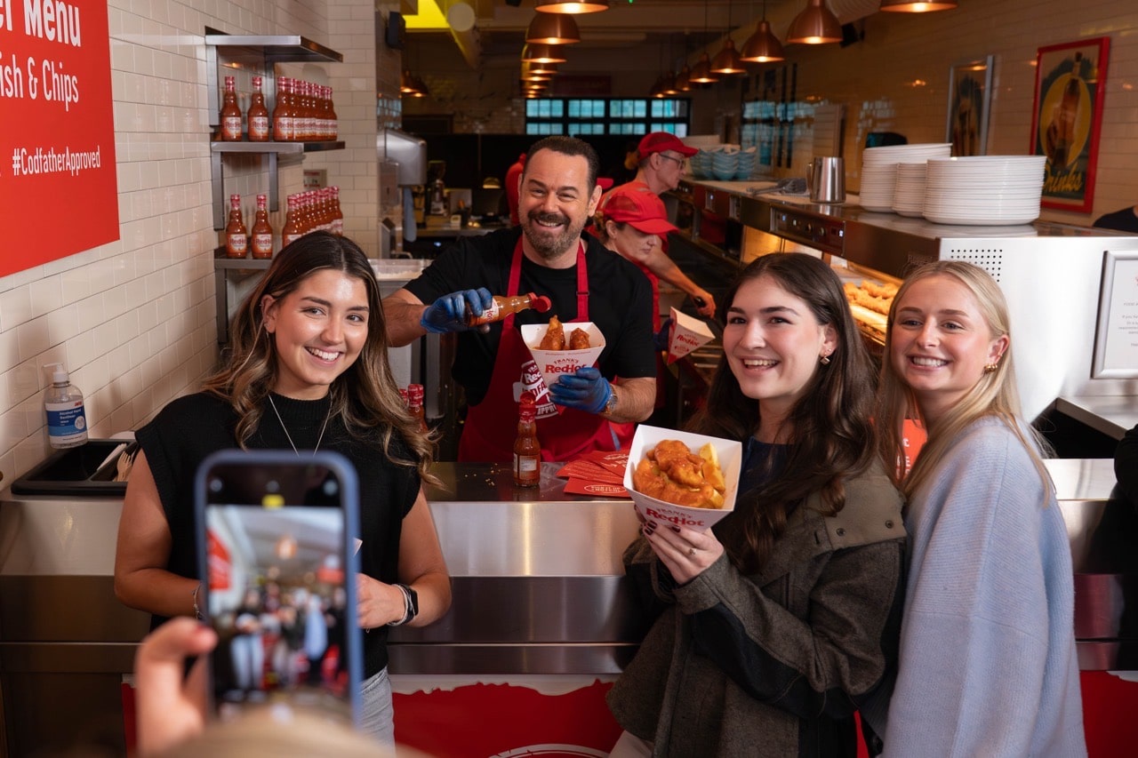 Danny Dyer RedHot sauce surprises fans by working a shift at a SoHo London chippy, kicking fish and chips up a notch with Frank’s RedHot sauce.