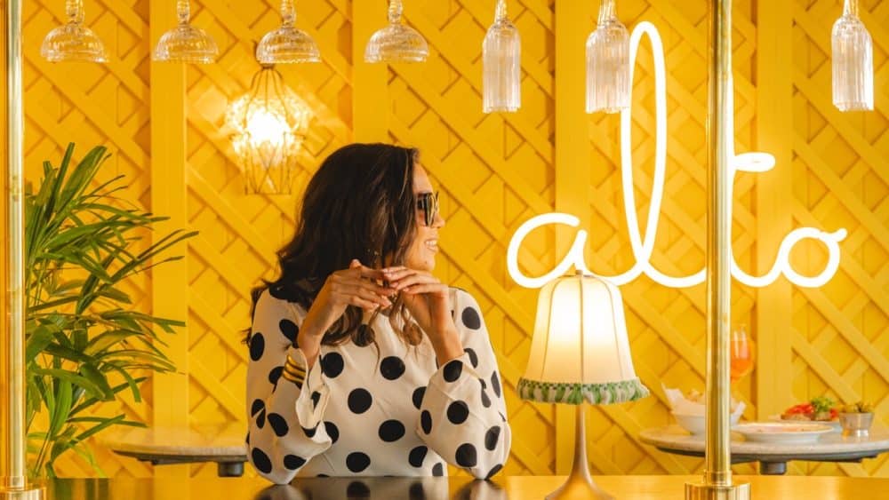 Woman dining at Alto by San Carlo rooftop bar